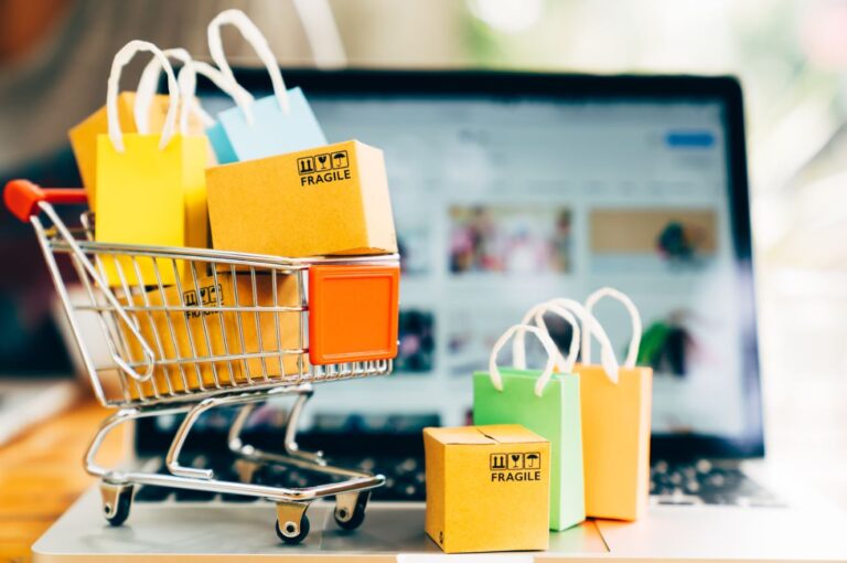 Online shopping cart and laptop